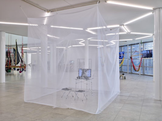 Interview with Betty Ann 2009, single-channel video, mosquito tent, folding chairs and table, monitor. Photo: Achim Kukulies
