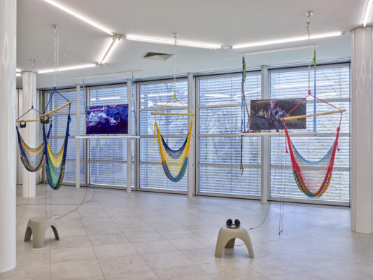 (left) I Plan to Stay a Believer - The Arcadia 4 Tree Sitting 2013, Blue Ray Video, hammocks; (right) Nonviolent Civil Disobedience Training - Tree Sitting Forest Defense 2009, single-channel video and platform, borrowed from John Quigley, environmental activist. Photo: Achim Kukulies
